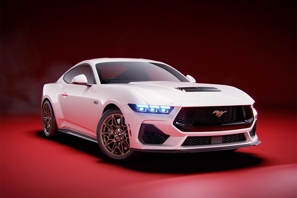 A Ford Mustang GT Fastback with Bronze Pack in Oxford White paint photographed in a studio with a red background.