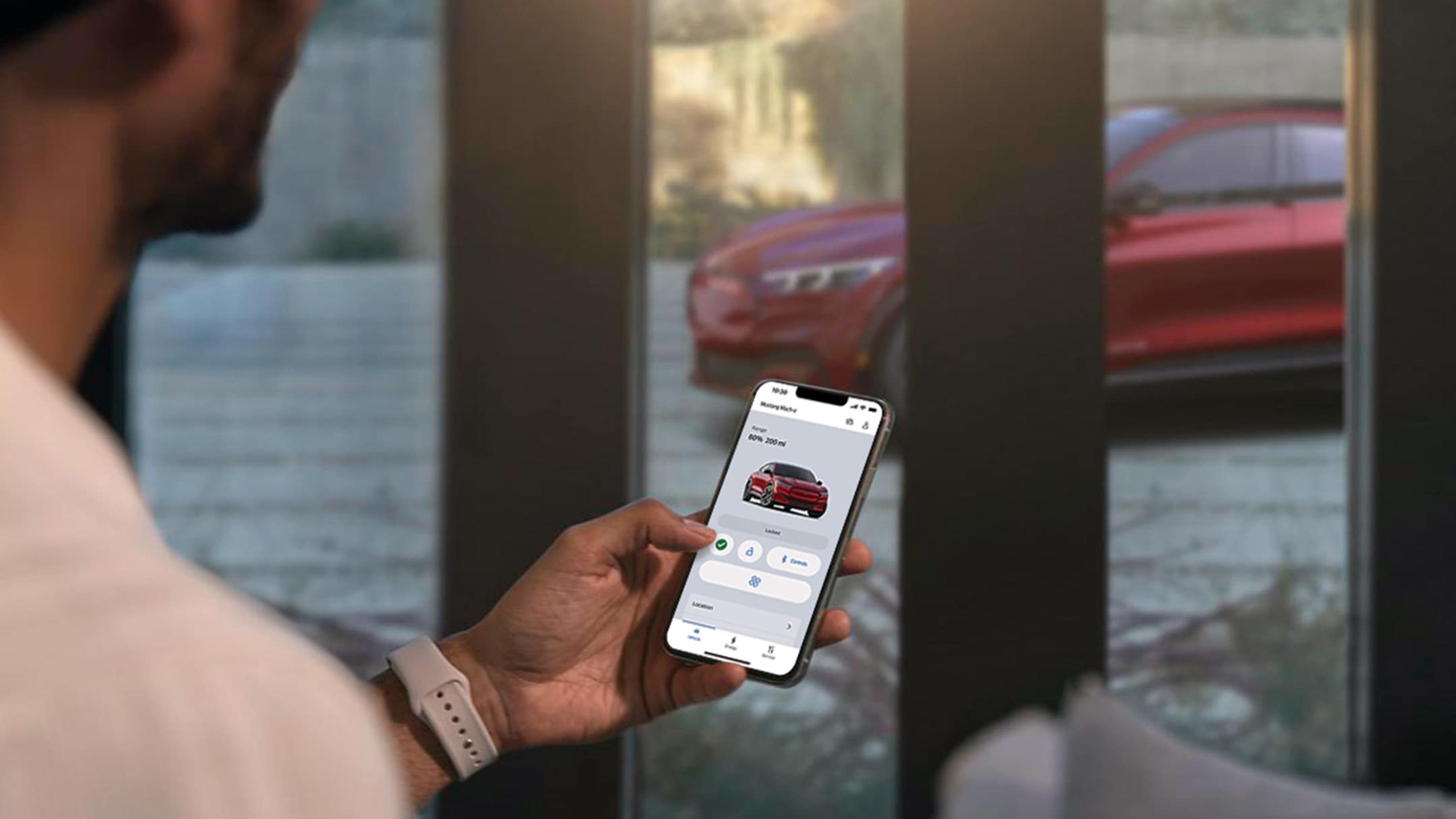 A man checking the settings of his All-New Ford Mustang Mach-E using the Remote Vehicle Control features in the FordPass app